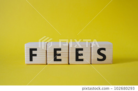 Fees symbol. Concept word Fees on wooden cubes. Beautiful yellow background. Business and Fees concept. Copy space. 102680293