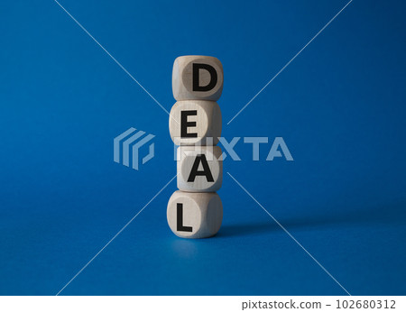 Deal symbol. Concept word Deal on wooden cubes. Beautiful blue background. Business and Deal concept. Copy space. Deal symbol. Concept word Deal on wooden cubes. Beautiful blue background. Business and Deal concept. Copy space. 102680312