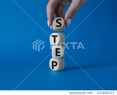 Step symbol. Concept word Step on wooden cubes. Businessman hand. Beautiful blue background. Business and Step concept. Copy space. 102680323