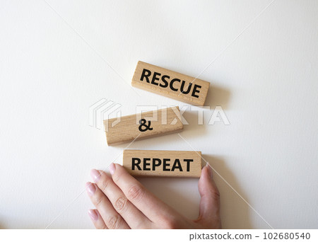 Rescue and Repeat symbol. Wooden blocks with words Rescue and Repeat. Beautiful white background. Businessman hand. Business and Rescue and Repeat concept. Copy space. 102680540