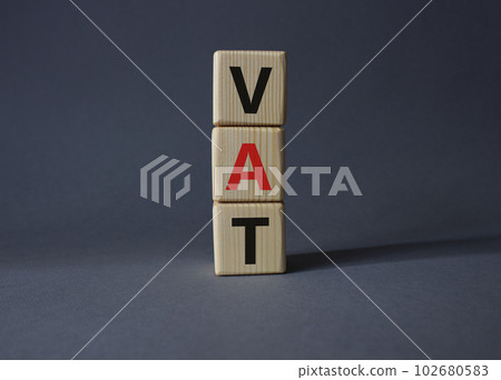 VAT - Value Added Tax symbol. Wooden cubes with word VAT. Beautiful grey background. Business and Value Added Tax concept. Copy space. VAT - Value Added Tax symbol. Wooden cubes with word VAT. Beautiful grey background. Business and Value Added Tax concept. Copy space. 102680583
