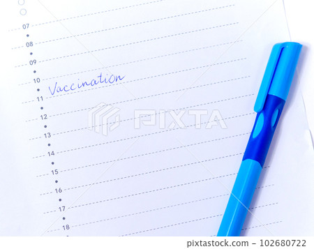 Close up view photo of word vaccination written in daily planner 102680722