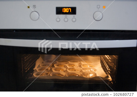 Paper cases filled with muffin dough 102680727