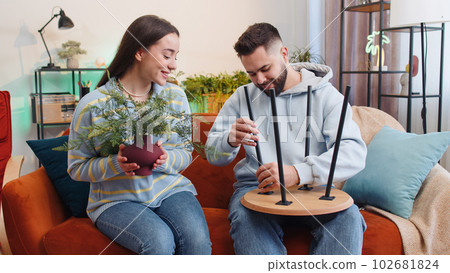 Man woman finishing assembling furniture at home apartment, successful table collect repair fixing Man woman finishing assembling furniture at home apartment, successful table collect repair fixing 102681824