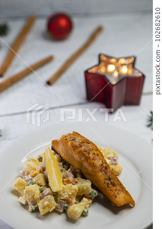 Traditional Christmas dinner in Czech Republic - salmon fillet with potato salad 102682610