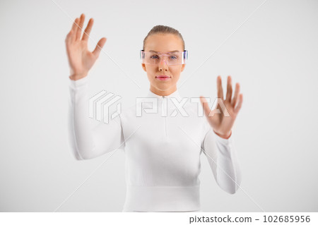 Woman wearing virtual reality smartglasses and gesturing Woman wearing virtual reality smartglasses and gesturing 102685956