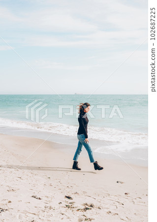 Young cheerful woman enjoing sunny day on the beach Young cheerful woman enjoing sunny day on the beach 102687225