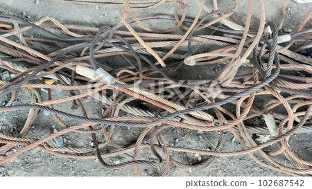 Pile of rusty tangled cable slings and wire rope. Pile of rusty tangled cable slings and wire rope. 102687542