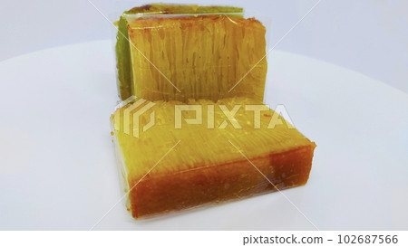 Bika ambon or golden cake or golden kuih bingka in Singapore, is an Indonesian dessert and authentic traditional food from asia. Bika ambon or golden cake or golden kuih bingka in Singapore, is an Indonesian dessert and authentic traditional food from asia. 102687566