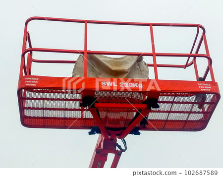 Orange boom lift platform with safety working weight 230 kg. Orange boom lift platform with safety working weight 230 kg. 102687589