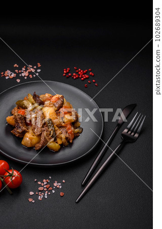 Delicious stew with potatoes, tomatoes, beef, onions and carrots Delicious stew with potatoes, tomatoes, beef, onions and carrots 102689304