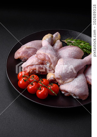 Raw chicken legs with salt, spices and herbs Raw chicken legs with salt, spices and herbs 102689318