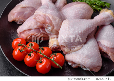 Raw chicken legs with salt, spices and herbs Raw chicken legs with salt, spices and herbs 102689319