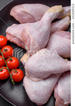 Raw chicken legs with salt, spices and herbs 102689322