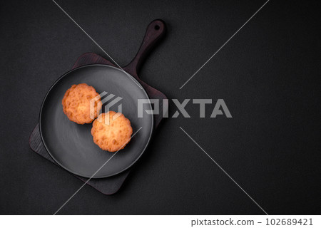 Delicious baked cupcake or tartlet with cheese and raisins Delicious baked cupcake or tartlet with cheese and raisins 102689421