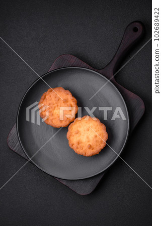 Delicious baked cupcake or tartlet with cheese and raisins Delicious baked cupcake or tartlet with cheese and raisins 102689422