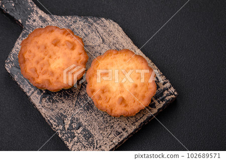 Delicious baked cupcake or tartlet with cheese and raisins 102689571