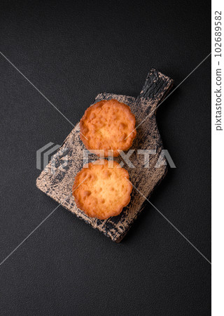Delicious baked cupcake or tartlet with cheese and raisins 102689582