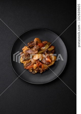 Delicious stew with potatoes, tomatoes, beef, onions and carrots Delicious stew with potatoes, tomatoes, beef, onions and carrots 102689605