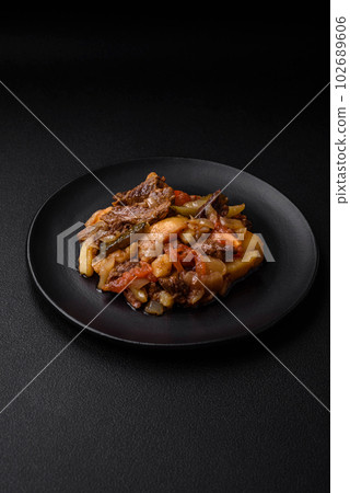 Delicious stew with potatoes, tomatoes, beef, onions and carrots 102689606
