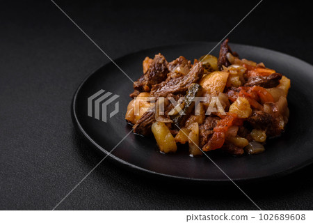 Delicious stew with potatoes, tomatoes, beef, onions and carrots 102689608