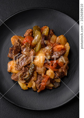 Delicious stew with potatoes, tomatoes, beef, onions and carrots 102689610