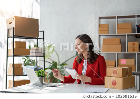 Startup small business SME, Entrepreneur owner using tablet taking receive and checking online purchase shopping order to preparing pack product box. Selling online ideas concept 102691639