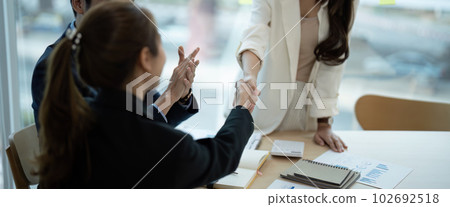 Young business people shaking hands in the office. Finishing successful meeting Young business people shaking hands in the office. Finishing successful meeting 102692518