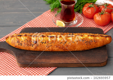 Close up of Turkish Pide bread on wooden table Close up of Turkish Pide bread on wooden table 102693957