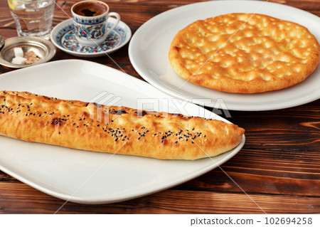 Baked homemade flatbread on wooden background close up 102694258