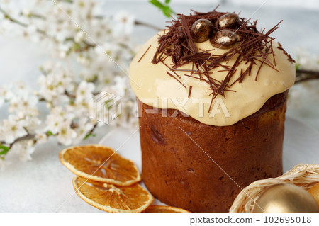 Easter cake and golden eggs on table Easter cake and golden eggs on table 102695018