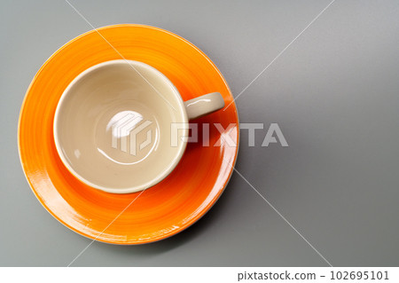 Top view of ceramic cup with saucer on gray background 102695101