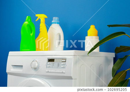 Bottle of detergent whith washing machine, indoors Bottle of detergent whith washing machine, indoors 102695205