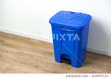 Plastic waste bin with lid in the room 102695319