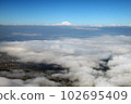 The sea of clouds seen from an airplane and the summit of Mt. Fuji thrust beyond it 102695409
