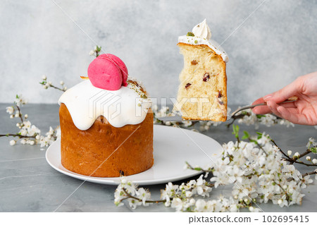 Hand holding piece of Easter cake on dessert spatula Hand holding piece of Easter cake on dessert spatula 102695415