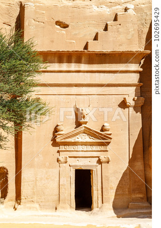 Carved ornamented entrance to the tomb at Jabal al banat complex, Hegra, Al Ula, Saudi Arabia Carved ornamented entrance to the tomb at Jabal al banat complex, Hegra, Al Ula, Saudi Arabia 102695429