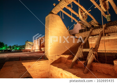 Diriyah old town well with highlighted wall in the background at night, Riyadh, Saudi Arabia Diriyah old town well with highlighted wall in the background at night, Riyadh, Saudi Arabia 102695435