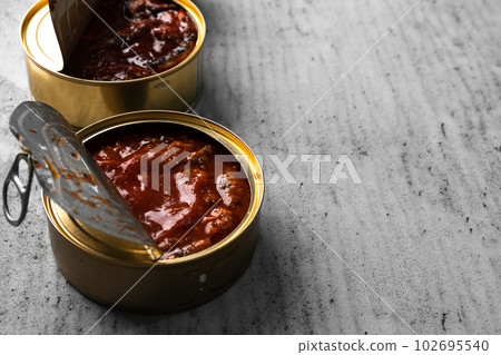 Open cans of canned fish on gray wooden table Open cans of canned fish on gray wooden table 102695540