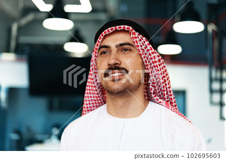 Successful muslim businessmen in traditional outfit in his office Successful muslim businessmen in traditional outfit in his office 102695603