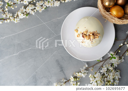 Easter cake and golden eggs on table Easter cake and golden eggs on table 102695677