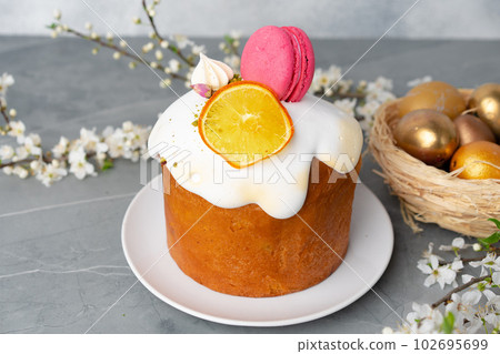 Beautiful Easter cake decorated with macarons cookie and dry orange piece Beautiful Easter cake decorated with macarons cookie and dry orange piece 102695699