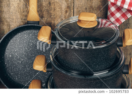 Set of cookware utensils on a kitchen counter 102695783