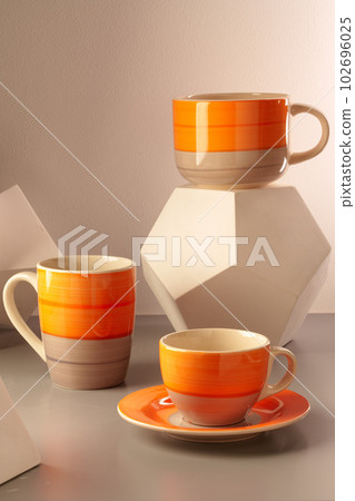 Colorful clay ceramic cups on gray background 102696025