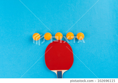 Ping pong racket and ball on blue background 102696115