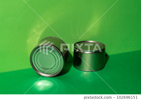 Canned food tin on green studio background Canned food tin on green studio background 102696151