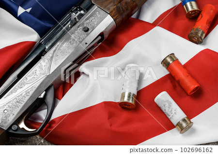 Automatic rifle on USA flag on wooden background 102696162