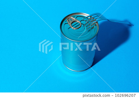 Tin can with food on blue background 102696207