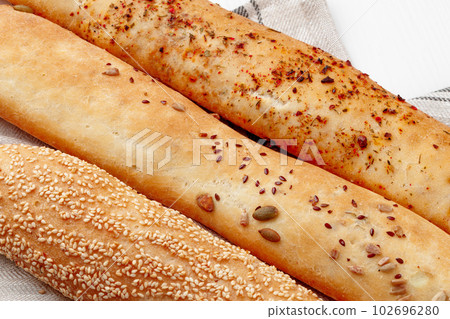 Fresh baguette bread on white wooden table 102696280