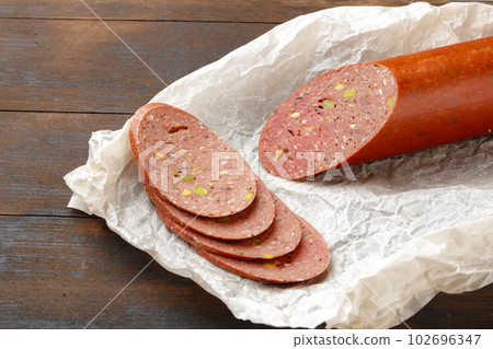 Chopped meat sausage on wooden board close up Chopped meat sausage on wooden board close up 102696347